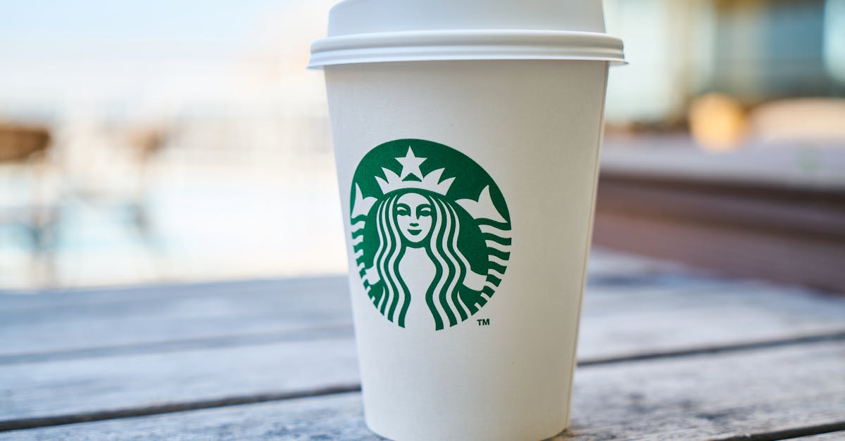 closed white and green starbucks disposable cup